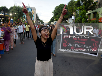 Citizens march along a street during a protest condemning the rape and murder of a trainee medic at a government-run hospital in Kolkata, In...