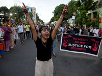 Citizens march along a street during a protest condemning the rape and murder of a trainee medic at a government-run hospital in Kolkata, In...