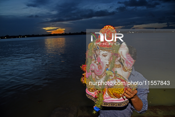 Indian Hindu devotees take part in the immersion of idols of the elephant-headed Hindu God Ganesh during the 'Ganesh Chaturthi' festival in...