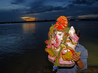 Indian Hindu devotees take part in the immersion of idols of the elephant-headed Hindu God Ganesh during the 'Ganesh Chaturthi' festival in...