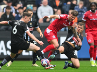 Lewis Macari of Notts County and Jack Hinchy of Notts County battle with Tyler Walton of Accrington Stanley during the Sky Bet League 2 matc...