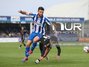 Nathan Sheron of Hartlepool United challenges Angelo Capello of FC Halifax Town during the Vanarama National League match between Hartlepool...