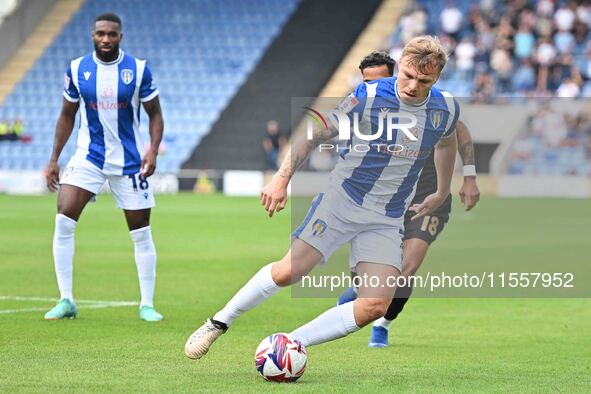 Harry Anderson (7 Colchester United) is challenged by Corey Whitely (18 Bromley) during the Sky Bet League 2 match between Colchester United...