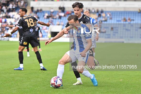 Jack Payne (10 Colchester United) is challenged by Besart Topalloi (23 Bromley) during the Sky Bet League 2 match between Colchester United...