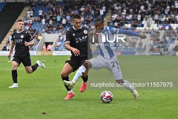 Owura Edwards (21 Colchester United) is challenged by Danny Imray (25 Bromley) during the Sky Bet League 2 match between Colchester United a...