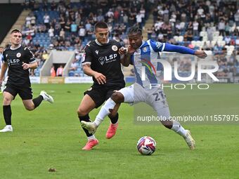 Owura Edwards (21 Colchester United) is challenged by Danny Imray (25 Bromley) during the Sky Bet League 2 match between Colchester United a...