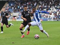 Owura Edwards (21 Colchester United) is challenged by Danny Imray (25 Bromley) during the Sky Bet League 2 match between Colchester United a...