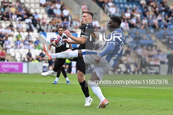 Deji Elerewe (3 Bromley) challenges Samson Tovide (9 Colchester United) during the Sky Bet League 2 match between Colchester United and Brom...