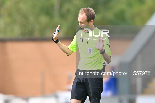 Referee Sam Purkiss holds his hands up during the Sky Bet League 2 match between Colchester United and Bromley at the Weston Homes Community...