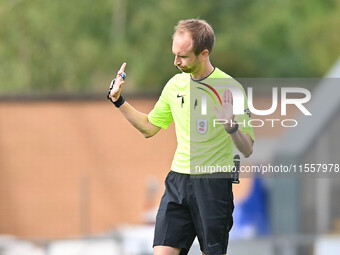 Referee Sam Purkiss holds his hands up during the Sky Bet League 2 match between Colchester United and Bromley at the Weston Homes Community...