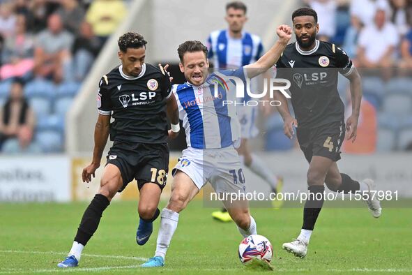 Jack Payne (10 Colchester United) is challenged by Corey Whitely (18 Bromley) during the Sky Bet League 2 match between Colchester United an...