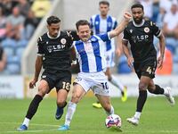 Jack Payne (10 Colchester United) is challenged by Corey Whitely (18 Bromley) during the Sky Bet League 2 match between Colchester United an...