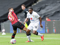 Milton Keynes Dons' Aaron Nemane skips past Walsall's George Hall during the first half of the Sky Bet League 2 match between MK Dons and Wa...