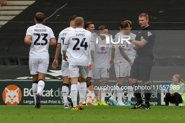 Callum Hendry celebrates with teammates after scoring for Milton Keynes Dons to take the lead, making it 1-0 against Walsall, during the fir...