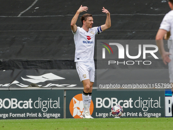 Alex Gilbey calls over players to celebrate Callum Hendry's goal for Milton Keynes Dons, taking the lead 1-0 against Walsall, during the fir...