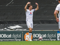 Alex Gilbey calls over players to celebrate Callum Hendry's goal for Milton Keynes Dons, taking the lead 1-0 against Walsall, during the fir...