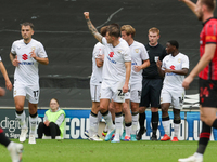 Callum Hendry celebrates with teammates after scoring for Milton Keynes Dons to take the lead, making it 1-0 against Walsall, during the fir...