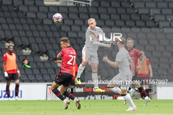 Connor Lemonheigh-Evans of Milton Keynes Dons heads the ball clear during the second half of the Sky Bet League 2 match between MK Dons and...