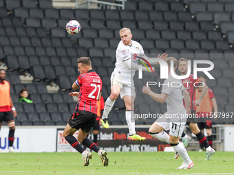 Connor Lemonheigh-Evans of Milton Keynes Dons heads the ball clear during the second half of the Sky Bet League 2 match between MK Dons and...