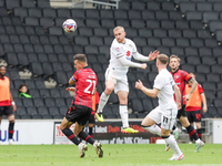 Connor Lemonheigh-Evans of Milton Keynes Dons heads the ball clear during the second half of the Sky Bet League 2 match between MK Dons and...