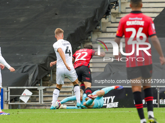 Milton Keynes Dons keeper Tom McGill makes a fingertip save to deny Walsall's Jamie Jellis' effort towards goal during the second half of th...