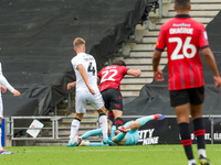 Milton Keynes Dons keeper Tom McGill makes a fingertip save to deny Walsall's Jamie Jellis' effort towards goal during the second half of th...