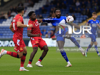 Emmanuel Monthe of Oldham Athletic Association Football Club tussles with Aribim Pepple of Southend United Football Club during the Vanarama...