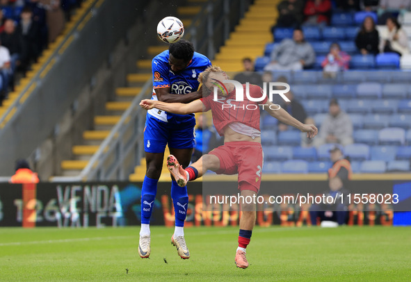 Emmanuel Monthe of Oldham Athletic Association Football Club tussles with Gus Scott-Morriss of Southend United Football Club during the Vana...