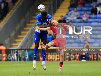 Emmanuel Monthe of Oldham Athletic Association Football Club tussles with Gus Scott-Morriss of Southend United Football Club during the Vana...