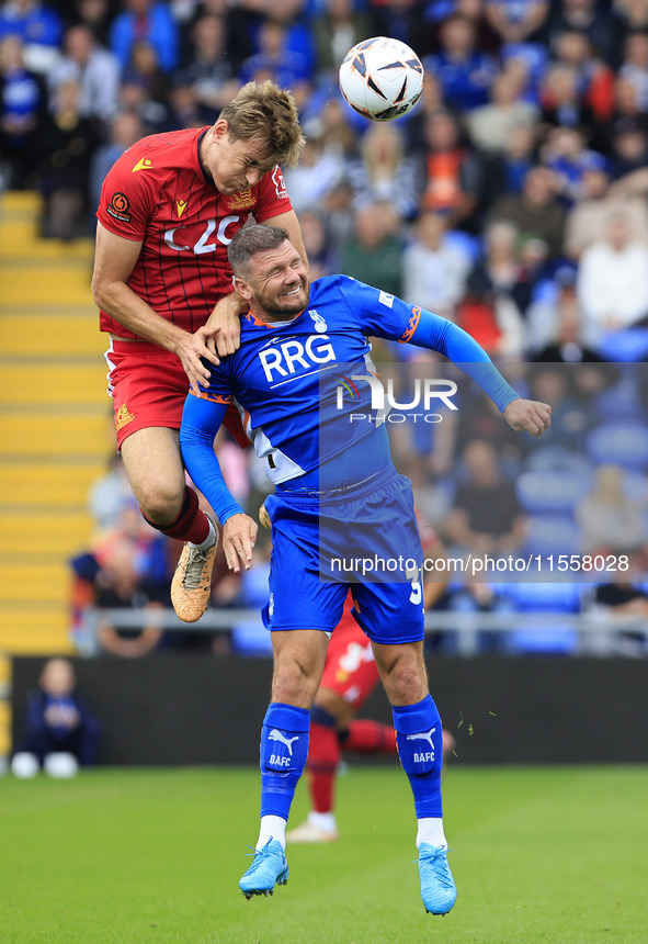 Adam Crowther of Southend United Football Club tussles with James Norwood of Oldham Athletic Association Football Club during the Vanarama N...