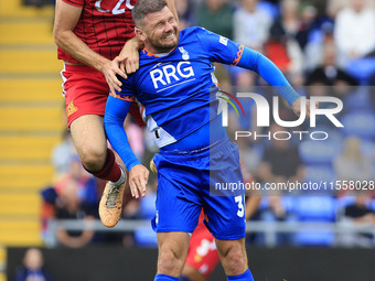 Adam Crowther of Southend United Football Club tussles with James Norwood of Oldham Athletic Association Football Club during the Vanarama N...