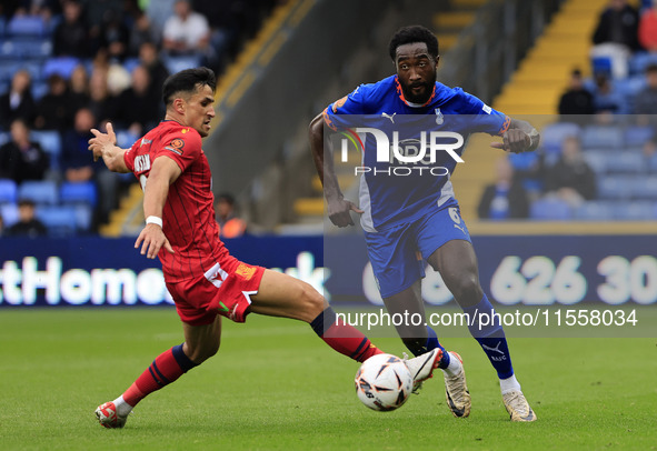 Emmanuel Monthe of Oldham Athletic Association Football Club tussles with Noor Husin of Southend United Football Club during the Vanarama Na...