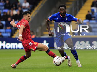 Emmanuel Monthe of Oldham Athletic Association Football Club tussles with Noor Husin of Southend United Football Club during the Vanarama Na...