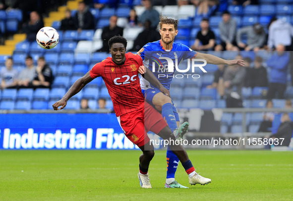 Charlie Raglan of Oldham Athletic Association Football Club tussles with Aribim Pepple of Southend United Football Club during the Vanarama...