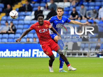 Charlie Raglan of Oldham Athletic Association Football Club tussles with Aribim Pepple of Southend United Football Club during the Vanarama...