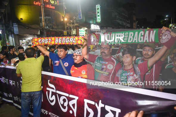 Supporters of East Bengal and Mohan Bagan club protest over the sexual assault and murder of a postgraduate woman doctor in Kolkata, India,...