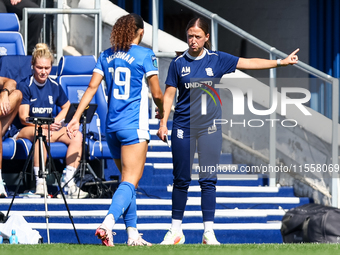 Amy Merricks, manager of Birmingham City, gestures as she is approached by #19, Tegan McGowan, during the FA Women's Championship match betw...