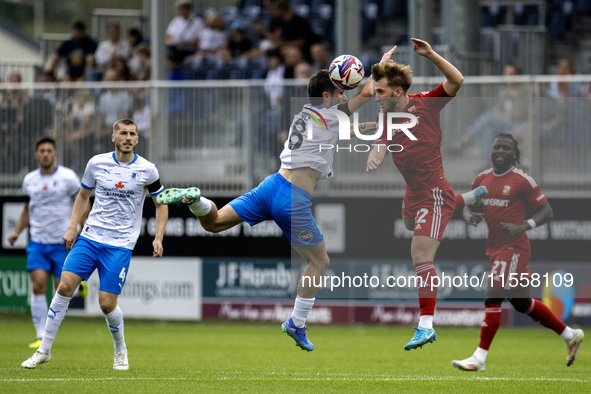 Barrow's Kian Spence challenges for a header with Swindon Town's Daniel Butterworth during the Sky Bet League 2 match between Barrow and Swi...