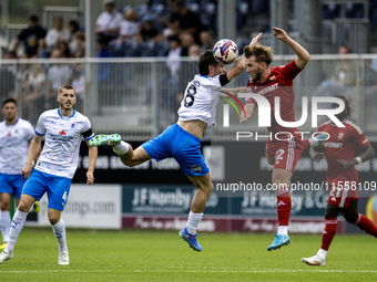 Barrow's Kian Spence challenges for a header with Swindon Town's Daniel Butterworth during the Sky Bet League 2 match between Barrow and Swi...