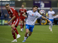 Barrow's Kian Spence competes with Swindon Town's Jack Cain during the Sky Bet League 2 match between Barrow and Swindon Town at Holker Stre...