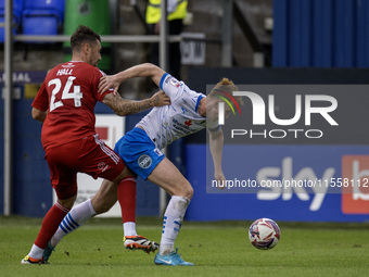 Rory Feely of Barrow battles for possession with Grant Hall of Swindon Town during the Sky Bet League 2 match between Barrow and Swindon Tow...