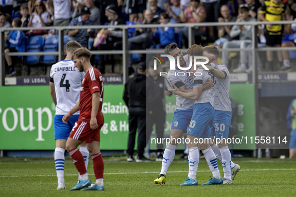 Barrow's Ged Garner celebrates with Dean Campbell and Ben Jackson after scoring their first goal during the Sky Bet League 2 match between B...