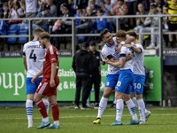 Barrow's Ged Garner celebrates with Dean Campbell and Ben Jackson after scoring their first goal during the Sky Bet League 2 match between B...