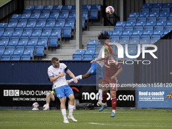 Barrow's Neo Eccleston challenges for a header with Swindon's Daniel Butterworth during the Sky Bet League 2 match between Barrow and Swindo...