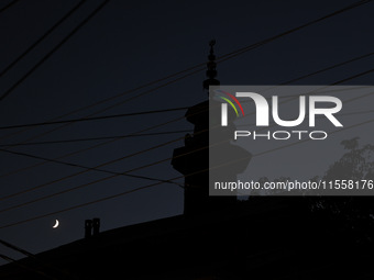 The crescent moon shines behind a mosque in Bandipora, Jammu and Kashmir, India, on September 8, 2024. (