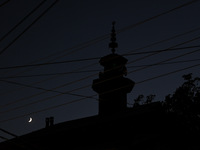 The crescent moon shines behind a mosque in Bandipora, Jammu and Kashmir, India, on September 8, 2024. (