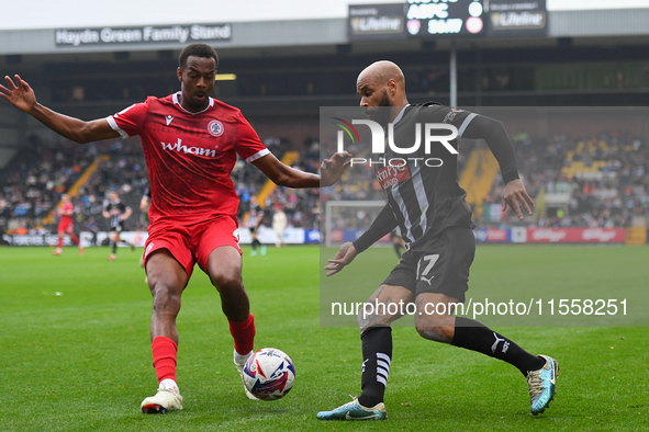 David McGoldrick of Notts County is under pressure from Zach Awe of Accrington Stanley during the Sky Bet League 2 match between Notts Count...