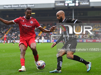 David McGoldrick of Notts County is under pressure from Zach Awe of Accrington Stanley during the Sky Bet League 2 match between Notts Count...