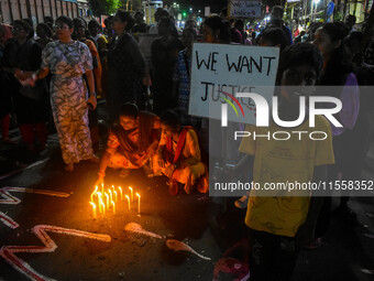 Citizens participate in a night vigil as the protest against the rape and murder of a second-year PGT doctor enters its 30th consecutive day...