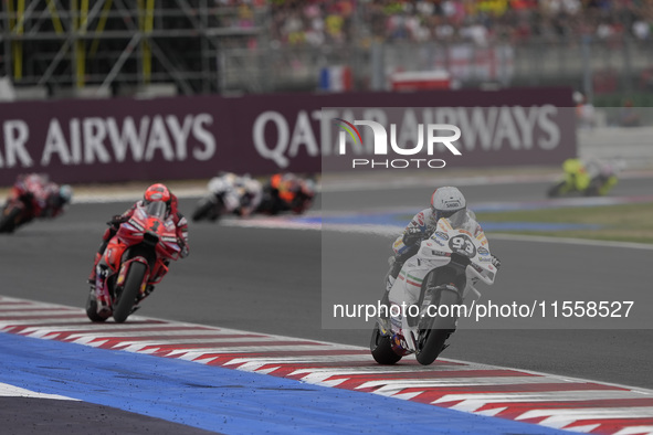 Marc Marquez rides on track in front of Francesco Bagnaia of Italy and the Ducati Lenovo Team during the Race of MotoGP of San Marino at Mis...